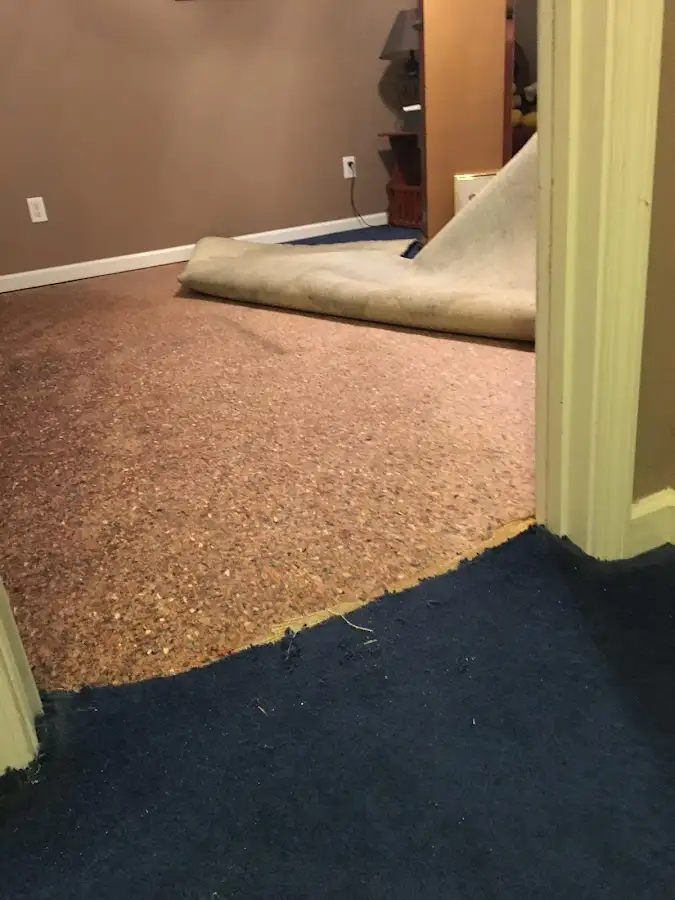 Carpet pad removal revealing water damage during Water Mitigation Services in Temescal Valley